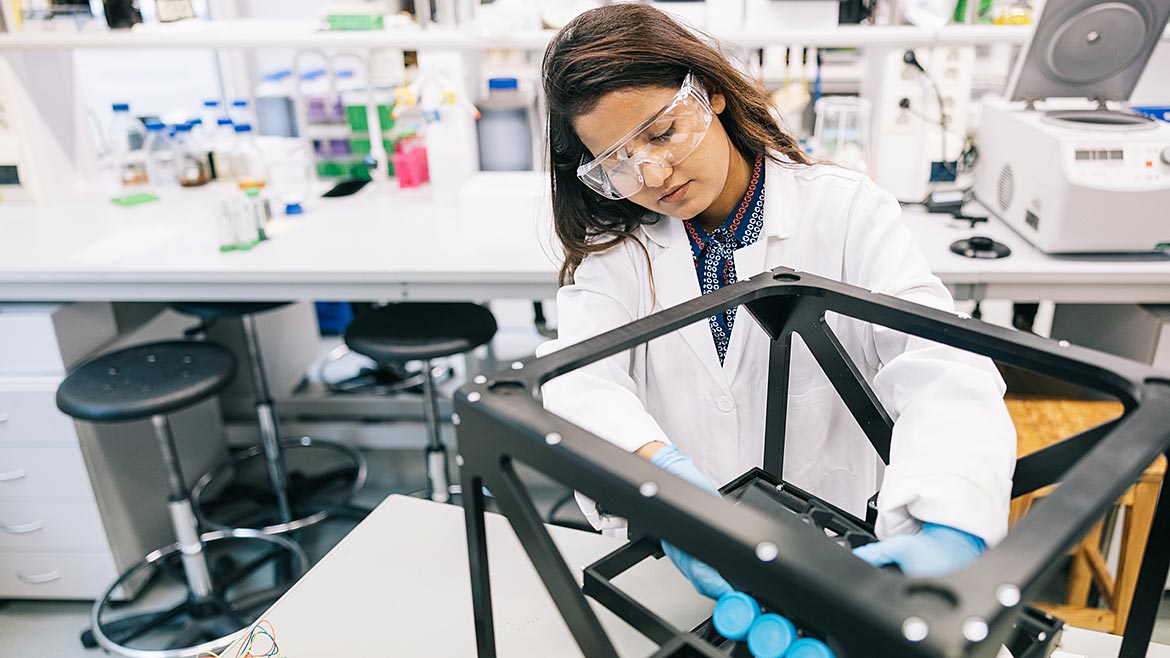 Female scientist is intently focused on perfecting the design of the prototype.