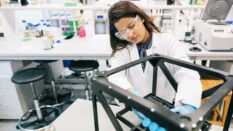 Female scientist is intently focused on perfecting the design of the prototype.