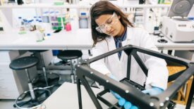 Female scientist is intently focused on perfecting the design of the prototype.