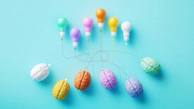 Colorful Lightbulbs Connected To Human Brains By Dotted Lines On Blue Background - Innovation and Teamwork Concept